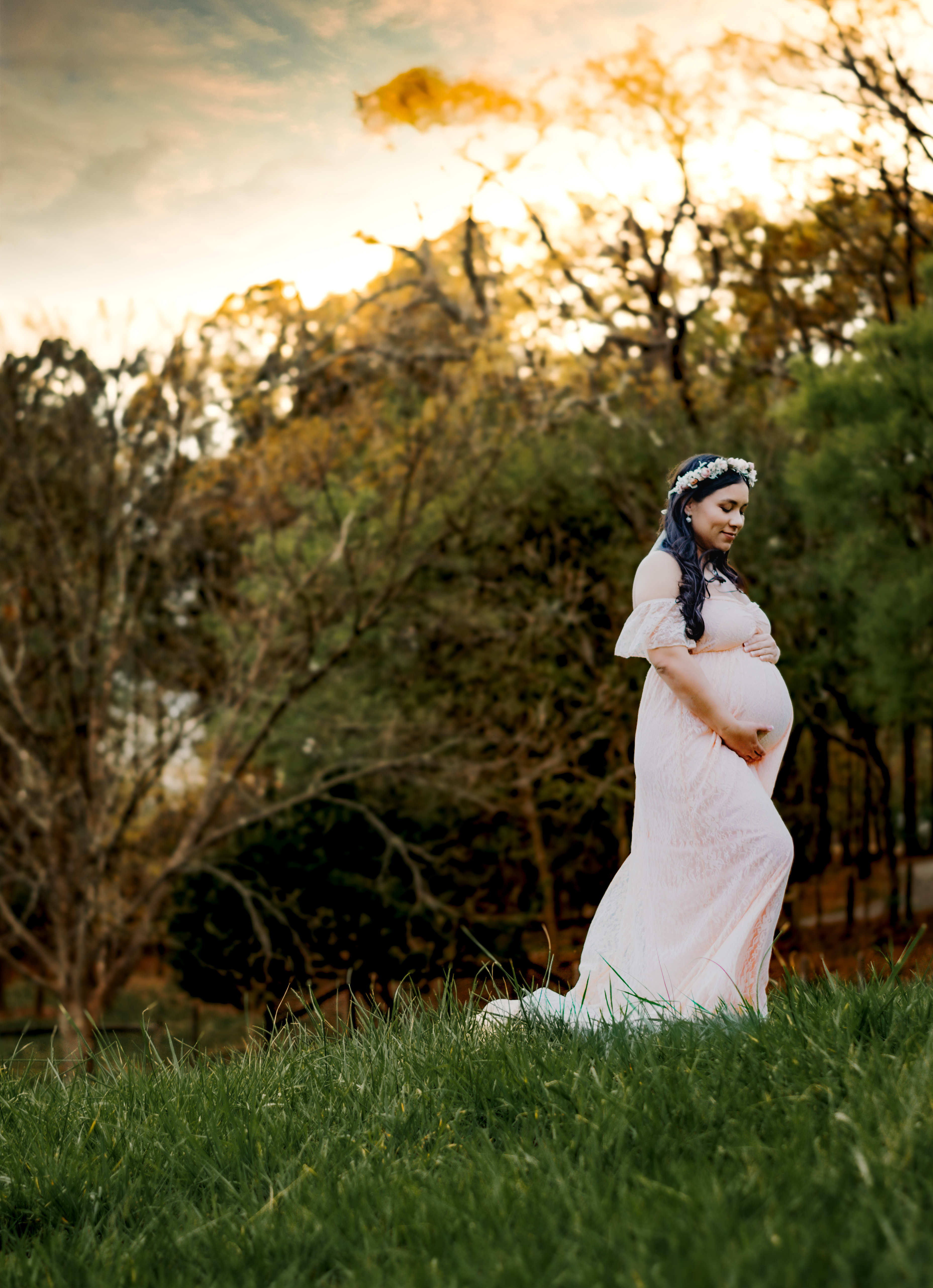 Pregnant woman stands in field at McDaniel Farm Park in Duluth