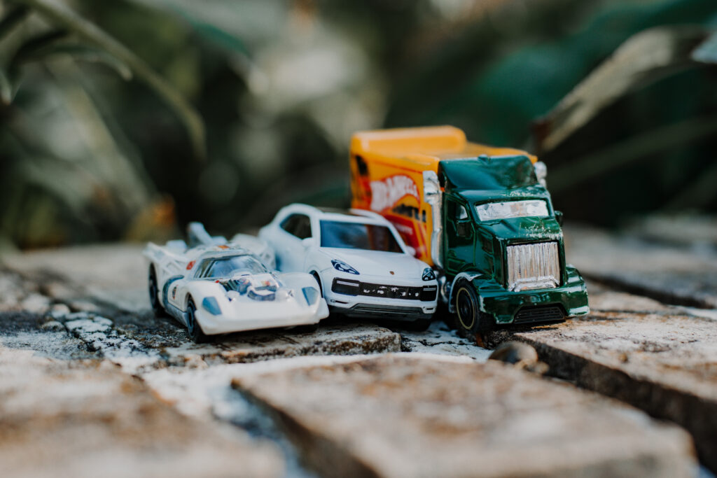 Picture of kids trucks sitting on a brick wall during a family photo session in Loganville, Georgia.