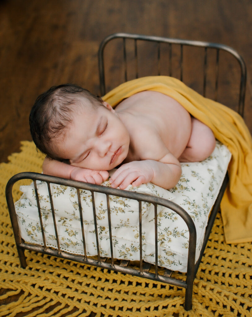 Sleepy baby posed on her tummy during a newborn photo session