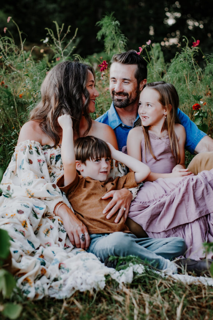 Family sits in wildflowers