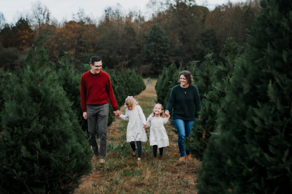 Family walks through Christmas tree farm