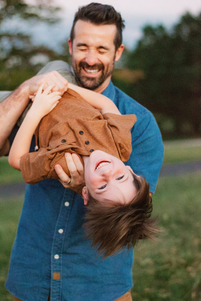 Dad and boy play on a farm