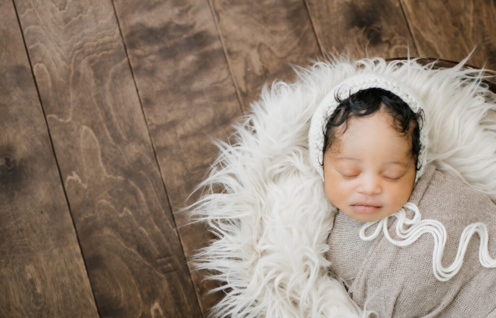 newborn swaddled in a bowl