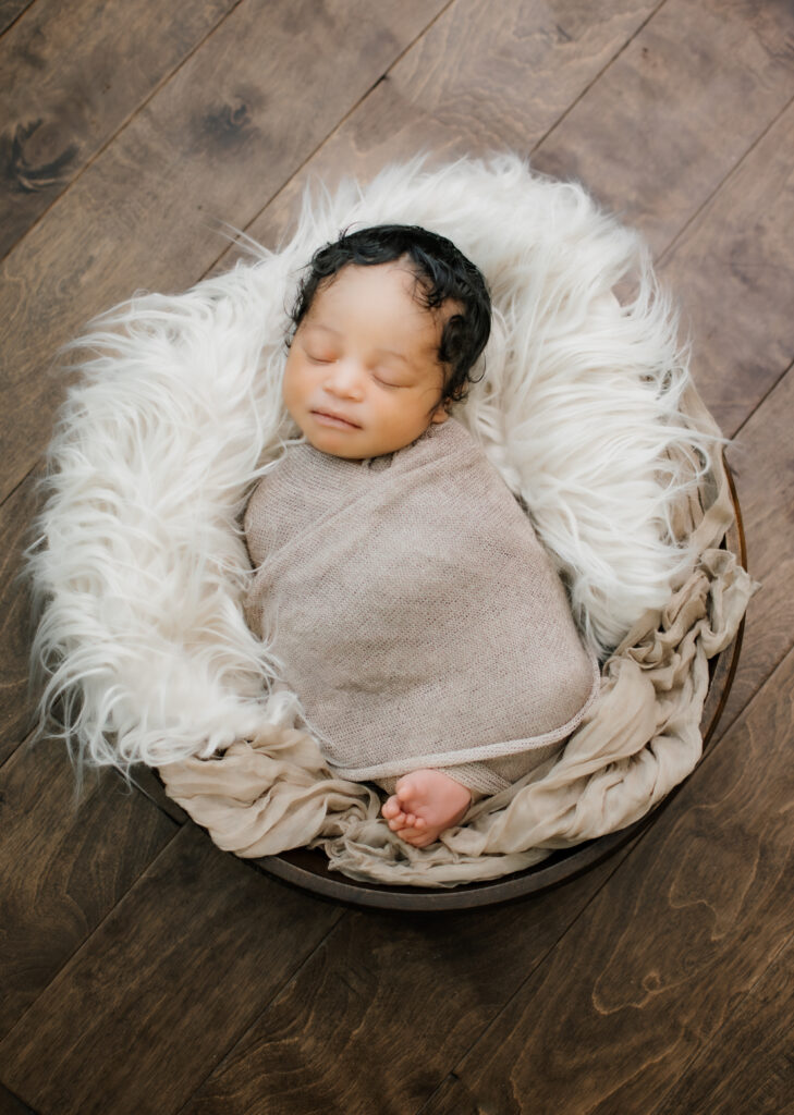 baby in bowl during in-home newborn session