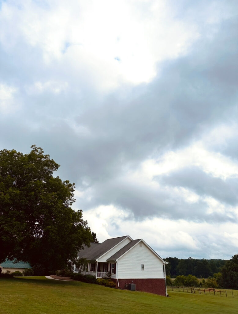 The Farmhouse at Prospect Farms, white house in a big field with a barn