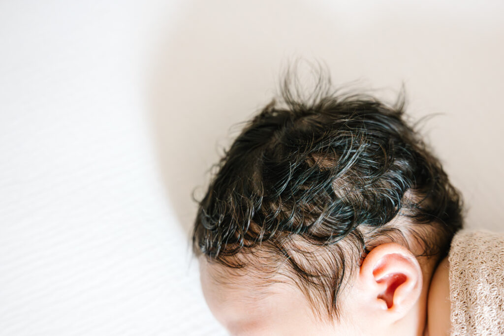 Close up of newborn baby's hair and ear.