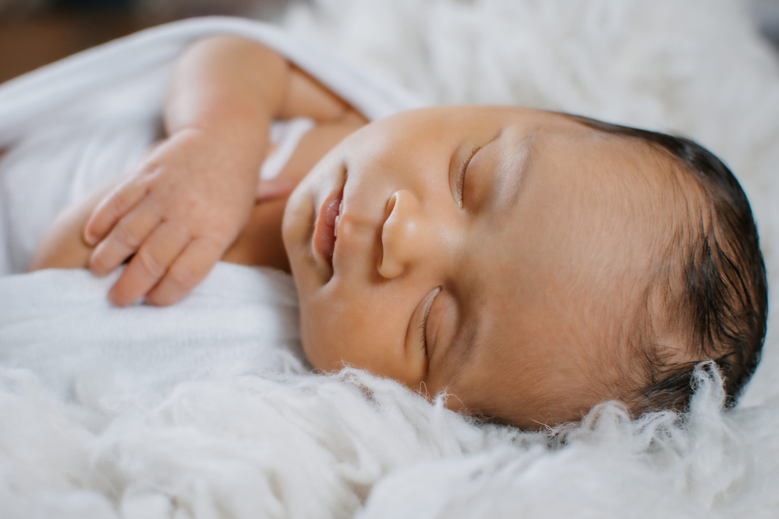 close of up sleeping baby during in-home newborn session