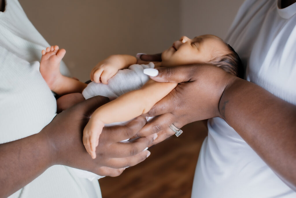 moms hold their newborn daughter in Grayson home