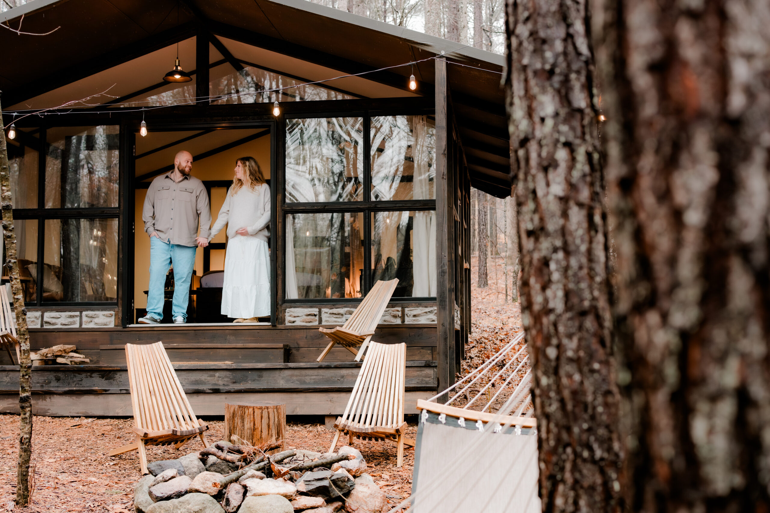 couple stands in open doorway during stone mountain maternity photo session