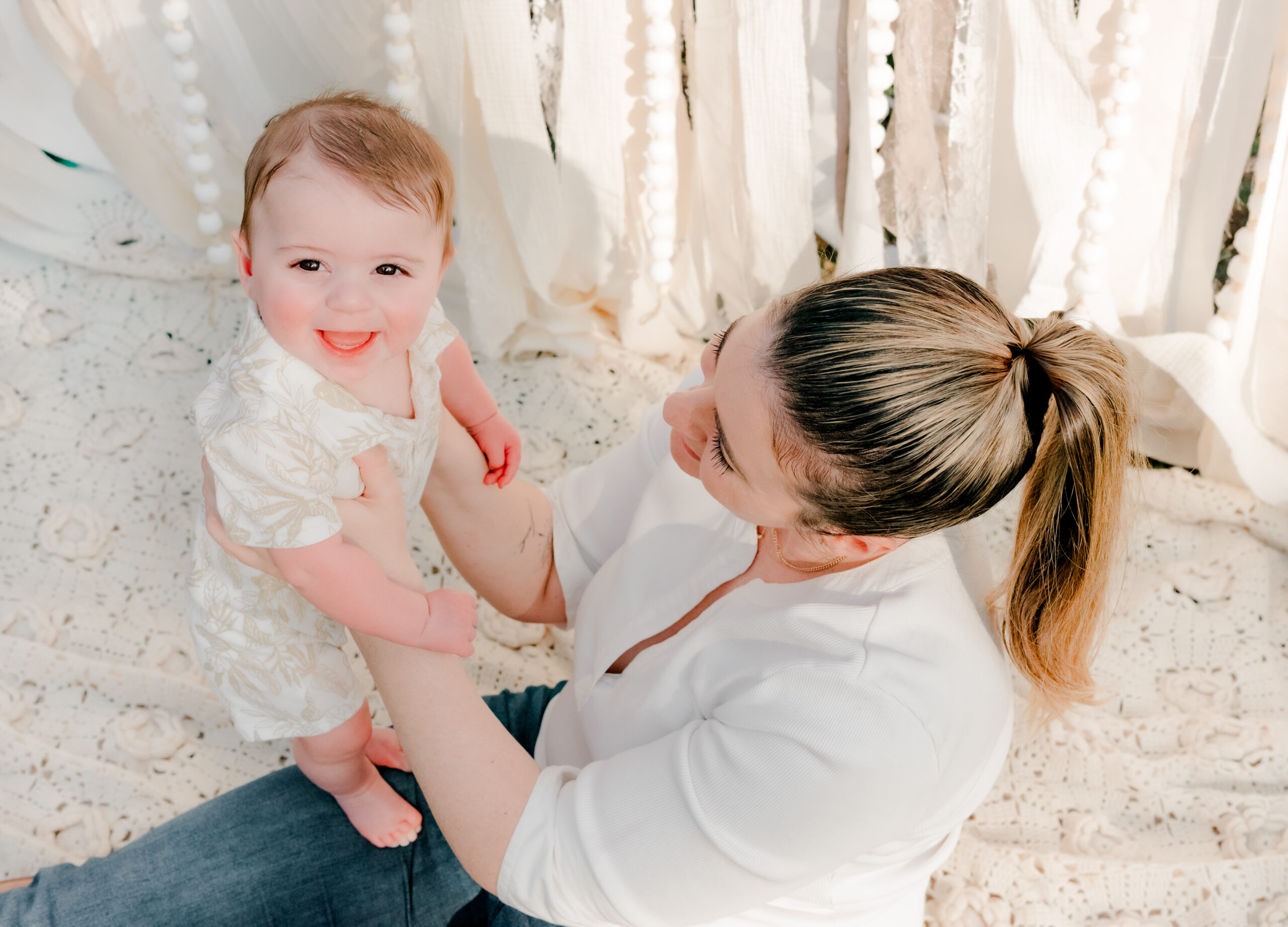 mom hold smiling baby at Lilburn City Park during mommy and me mini session
