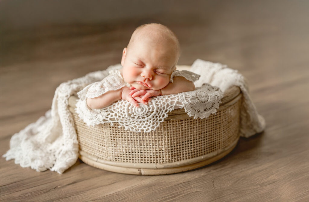 newborn posed in basket during in-home photoshoot