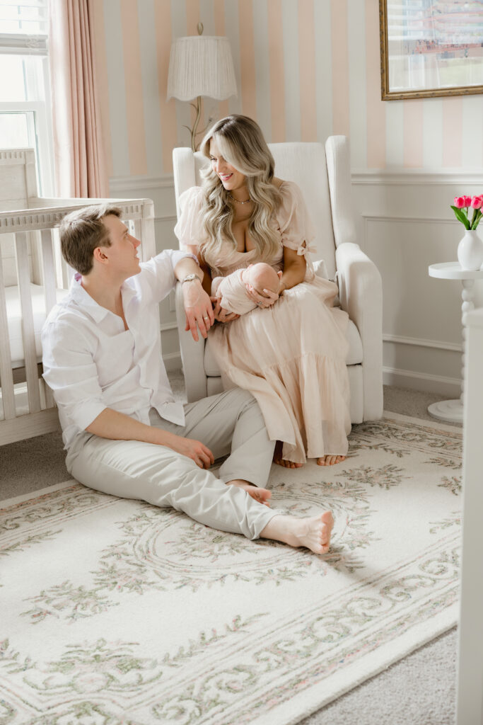 atlanta couple in nursery gazing at each other over newborn baby