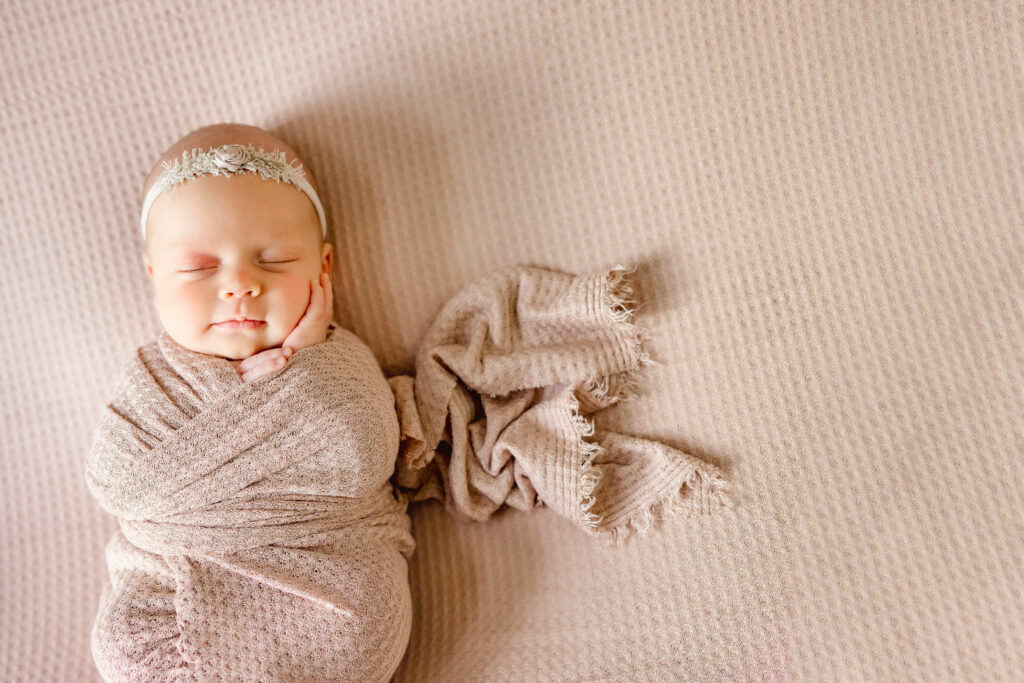 wrapped baby in pink fabric newborn session
