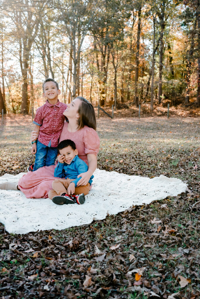 Mom and sons sit on blanket during golden hour family session in Atlanta, Georgia.