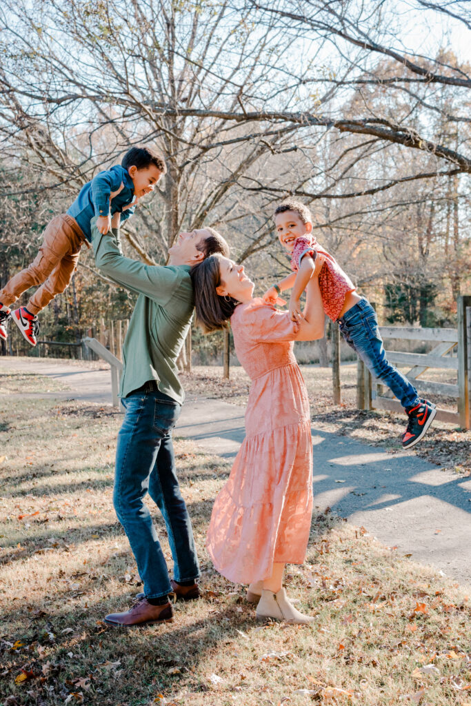 kids lifted into the air during family photo session in Duluth, Georgia