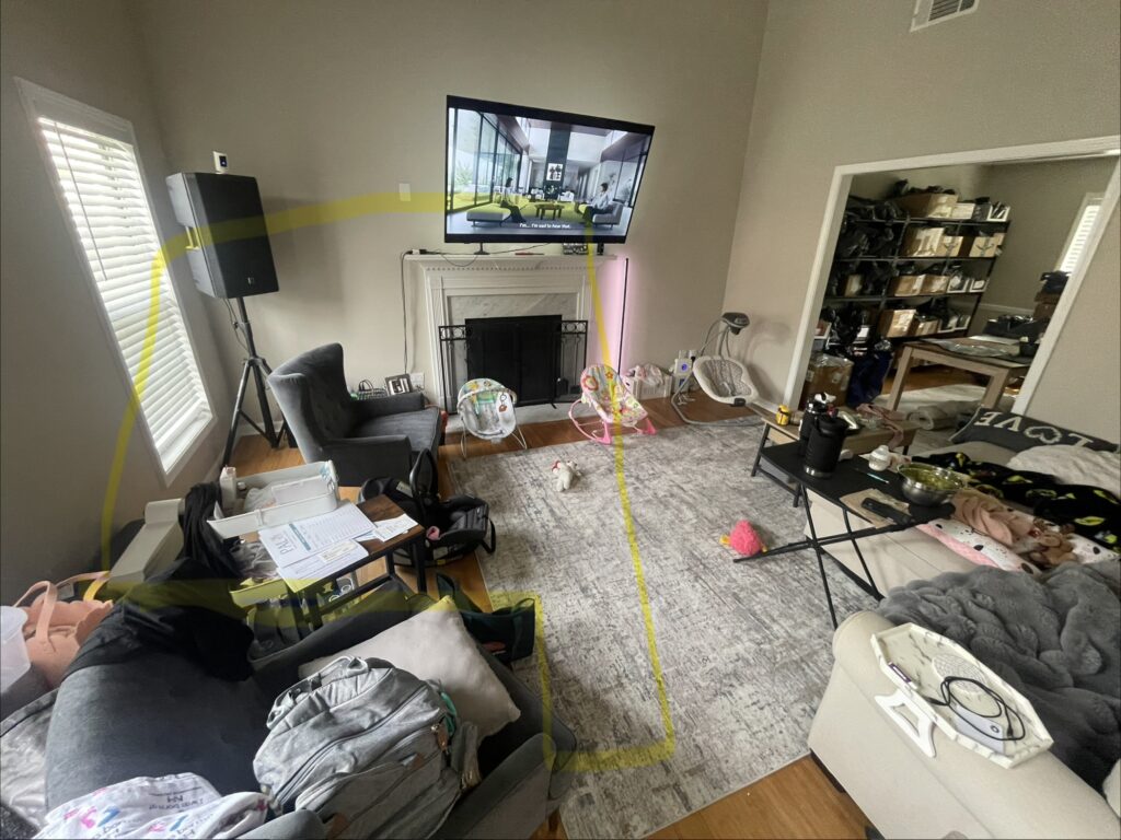 messy living room in Lawrenceville, Georgia home with a yellow mark around he corner